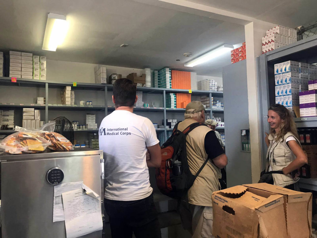 Kristin shows the improved warehouse to representatives from the Office of U.S. Foreign Disaster Assistance (OFDA).