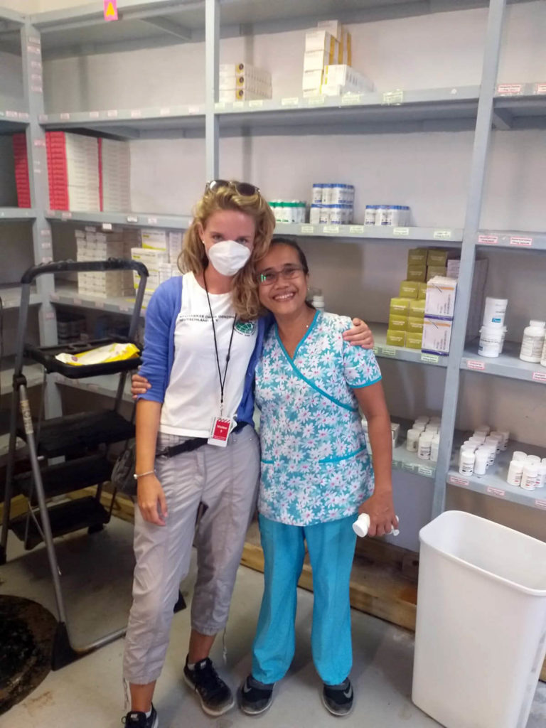 Kristin poses with Rand Memorial Hospital Pharmacist Judith Villahermosa at the pharmacy warehouse.