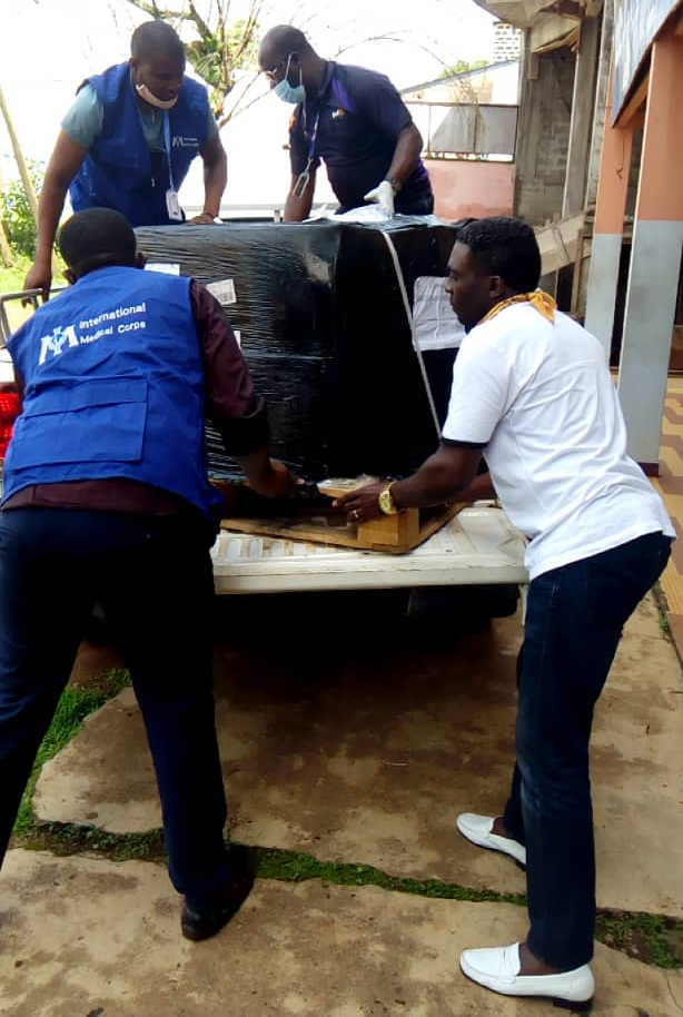 International Medical Corps staff members in Cameroon unload a shipment of PPE from a truck in June.