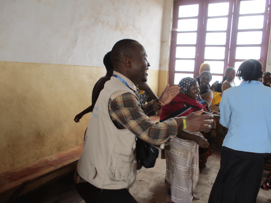 Mussa celebrates with women in International Medical Corps’ “women’s safe space,” which enables women at risk of gender-based violence to come together, receive support and learn new skills in North Kivu province, DRC.