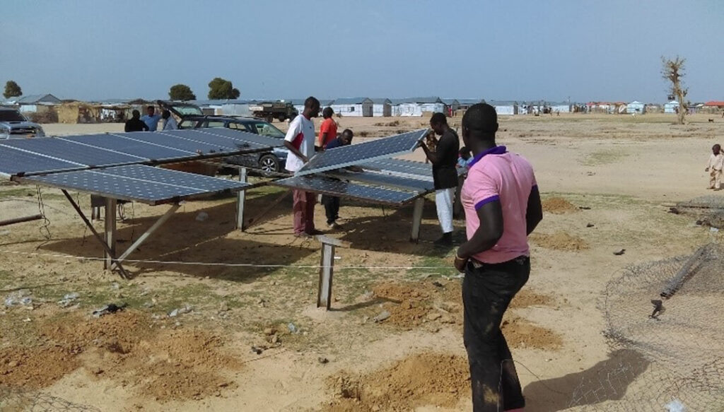 International Medical Corps contractors install solar panels to power the borehole water system in Damboa, Nigeria.