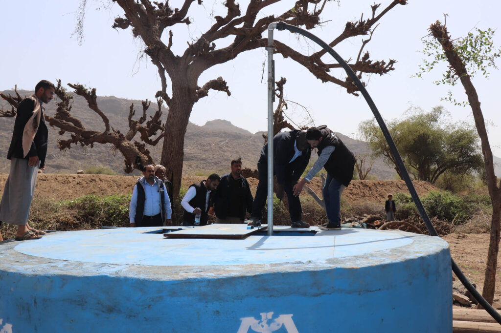 This covered water tank is part of a solar-powered water system in Sana’a governorate, Yemen. An uncovered and exposed well can spread waterborne diseases like cholera; a submerged pump and covered tank reduce disease risk.