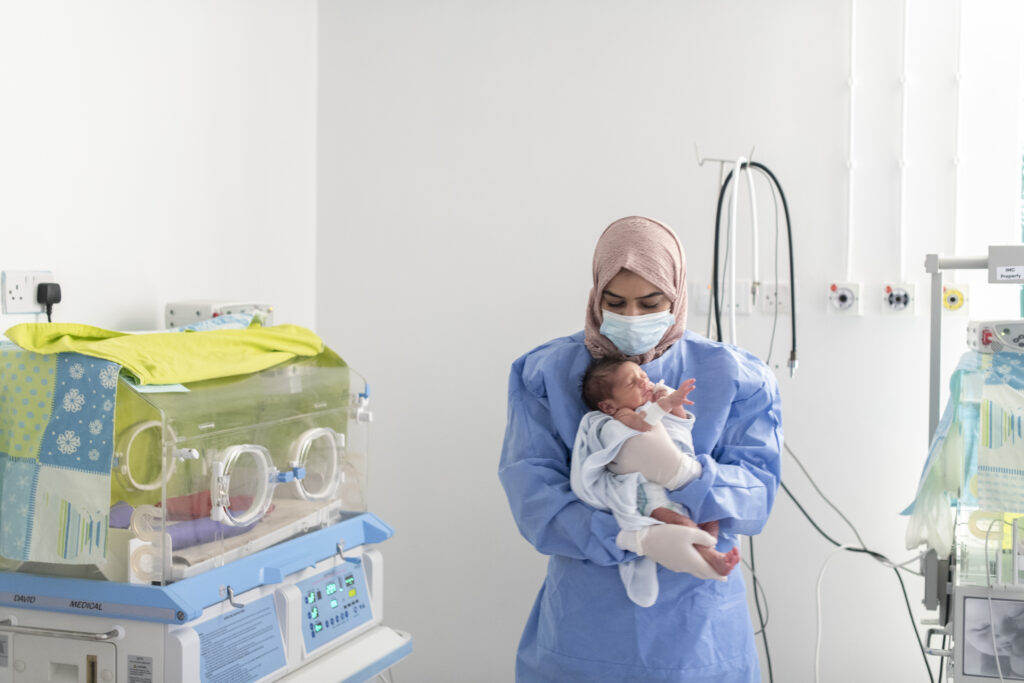 NICU nurse Maha bathing a baby at the International Medical Corps - NICU unit in Irbid Specialty Hospital, Irbid, Jordan.