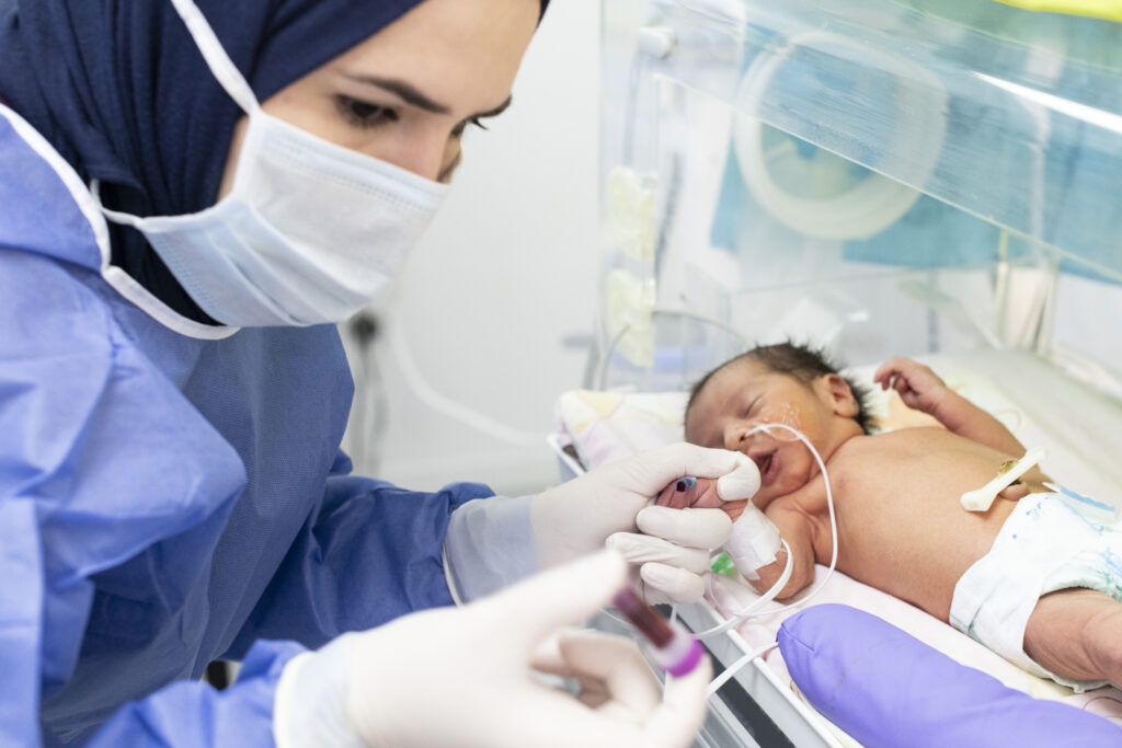 NICU nurse Zubaida takes a blood sample from a baby at the International Medical Corps - NICU unit in Irbid Specialty Hospital, Irbid, Jordan.