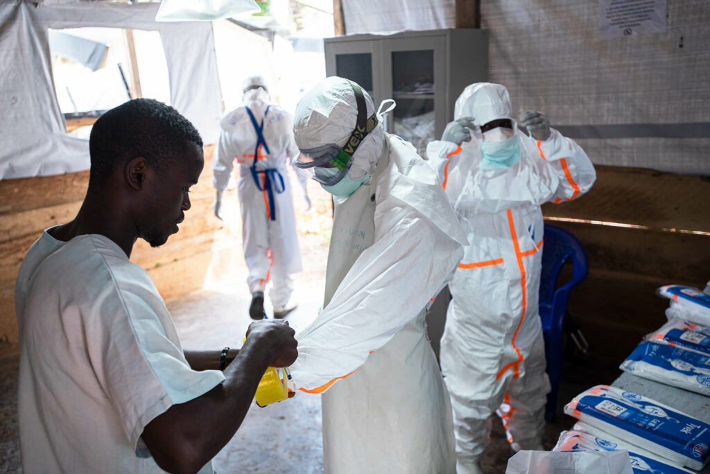 Medical staff in DRC don PPE before entering an area where patients with Ebola are quarantined.