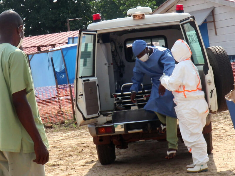 Nurses help a patient with a suspected case of Ebola to get out of an ambulance at Wangata Ebola Treatment Center in Équateur Province, DRC.