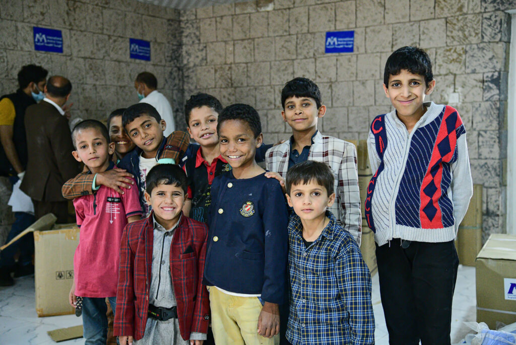 Young residents of the orphanage pose outside the refurbished clinic.