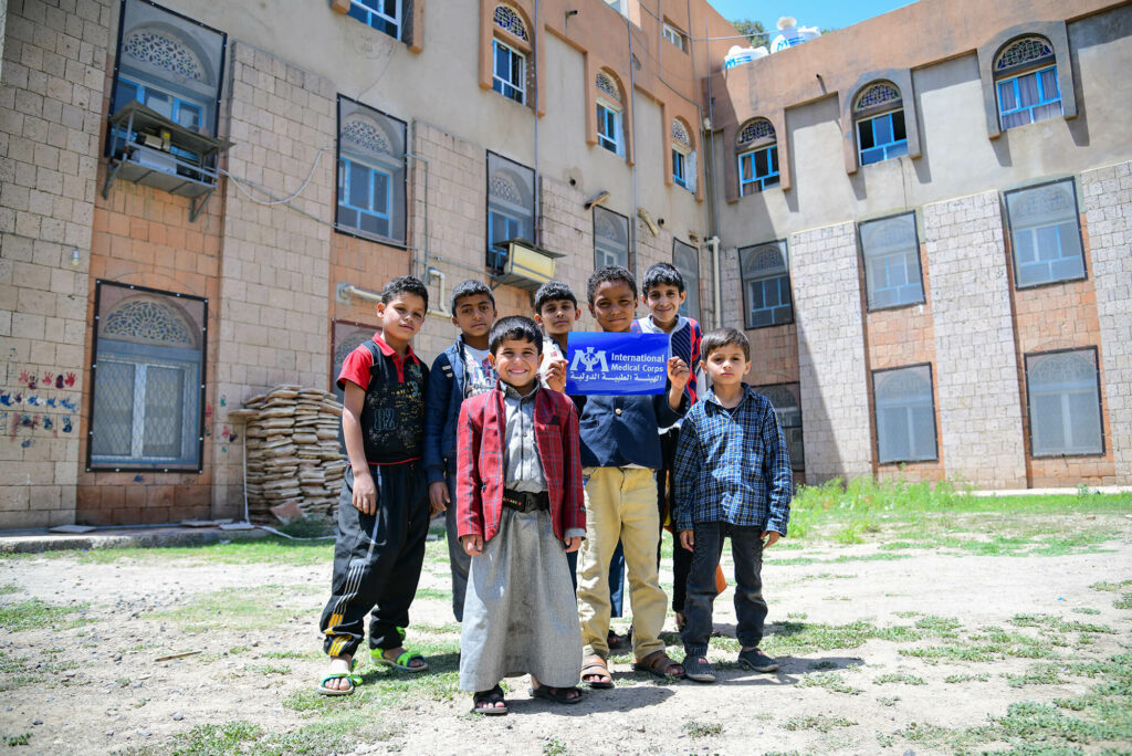 Young residents of the orphanage pose outside the refurbished clinic.