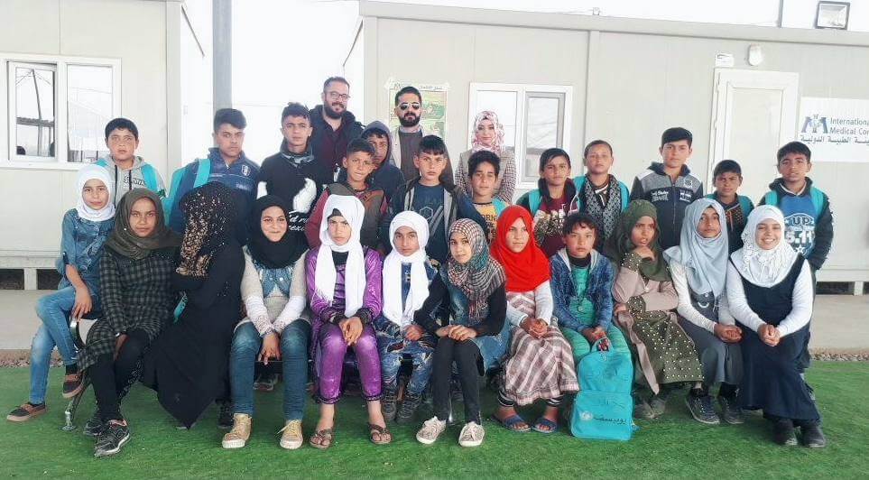Dr. Furat (center, top) with a team of junior community health workers in Hammam al-alil camp.