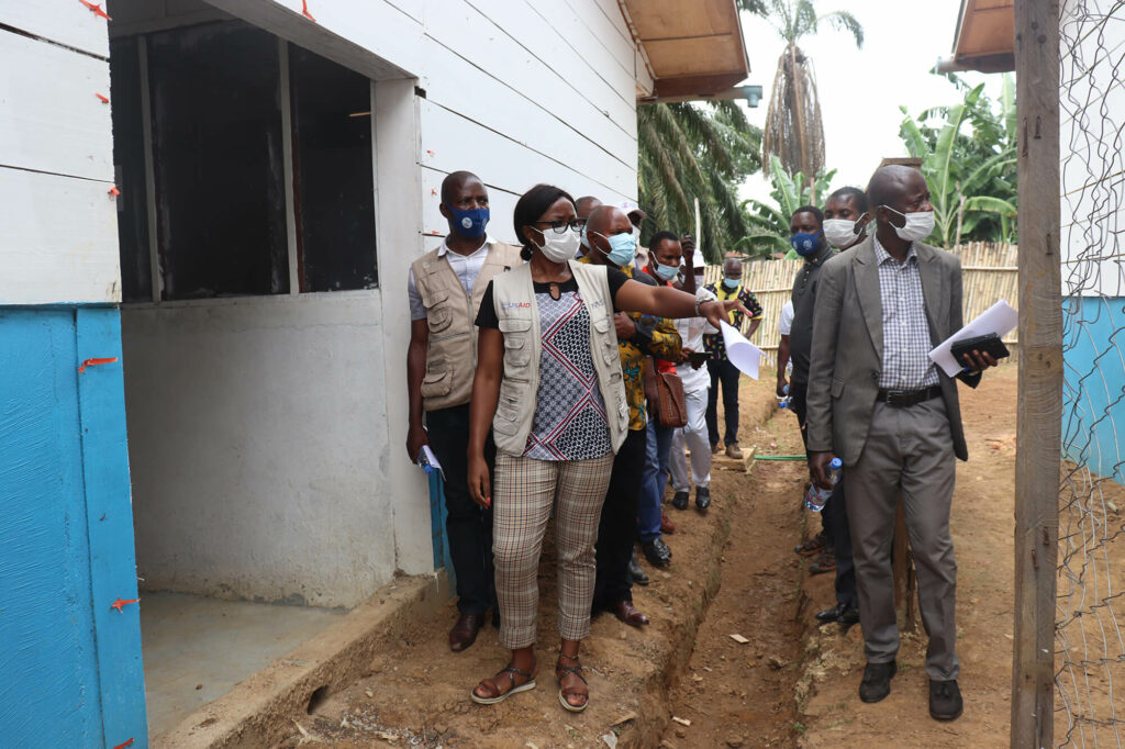 An International Medical Corps nurse supervisor shows local leaders and community members the Ebola treatment center in Bikoro, Équateur province.