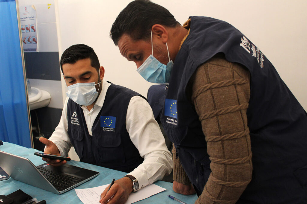 Dr. Sanad Attia and Khaled Hassan, a nurse, review files at Al-Medina Al-Kadima primary healthcare center (PHCC) in Tripoli.