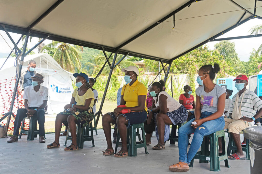 Patients wait in the International Medical Corps field hospital in Aquin.