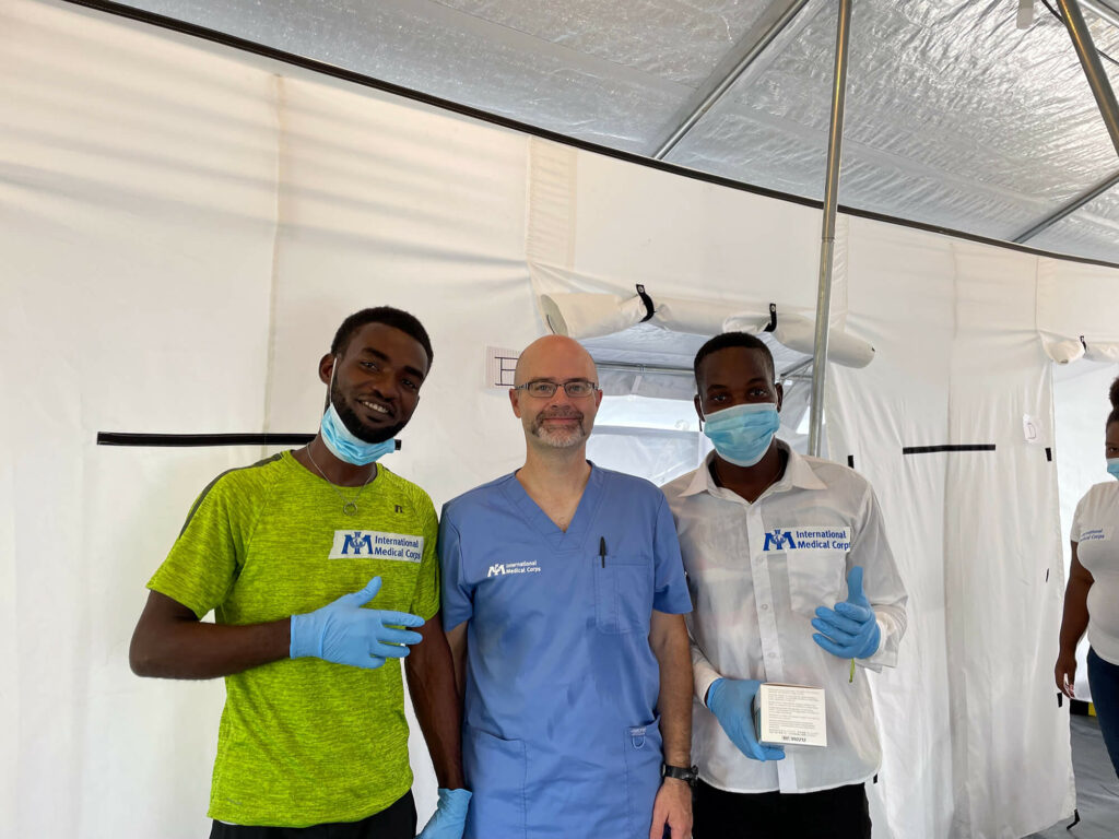 Dr. Chad Knaus (center) poses with two local Haitian translators, Nico Grefin (left) and Joseph Johnny.