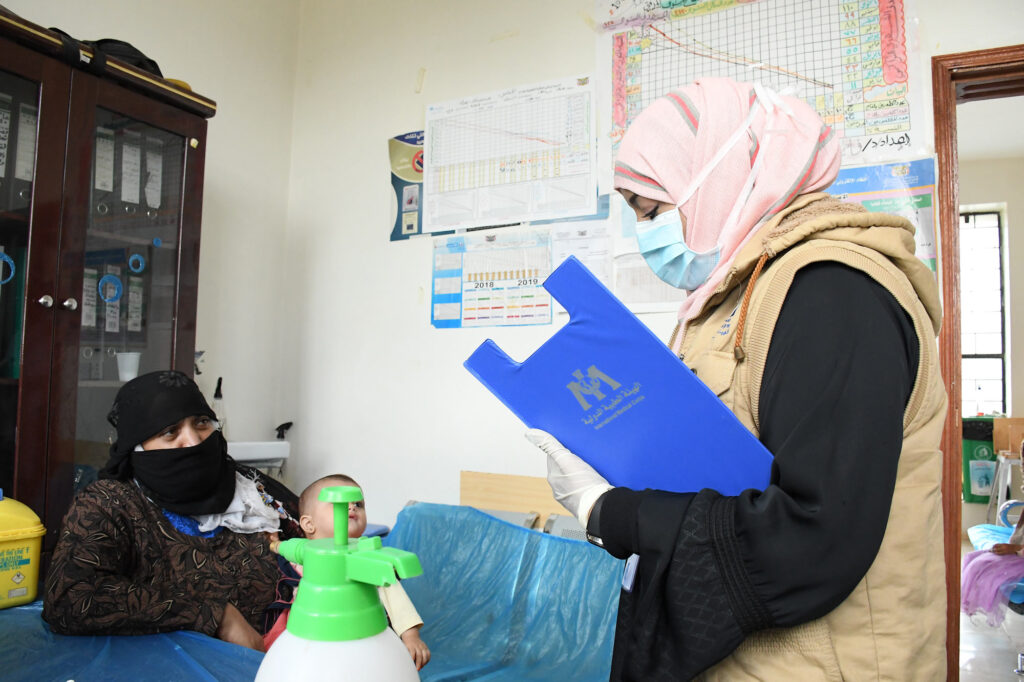 Health Program Manager Dr. Nebras Khalid with two patients at a health facility we support in Sana’a Governorate.