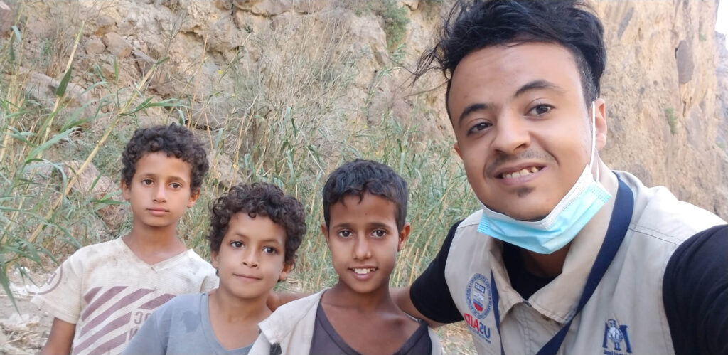 Fayad poses with young residents of a village in a remote area of southwest Yemen where his team conducted water restoration projects.