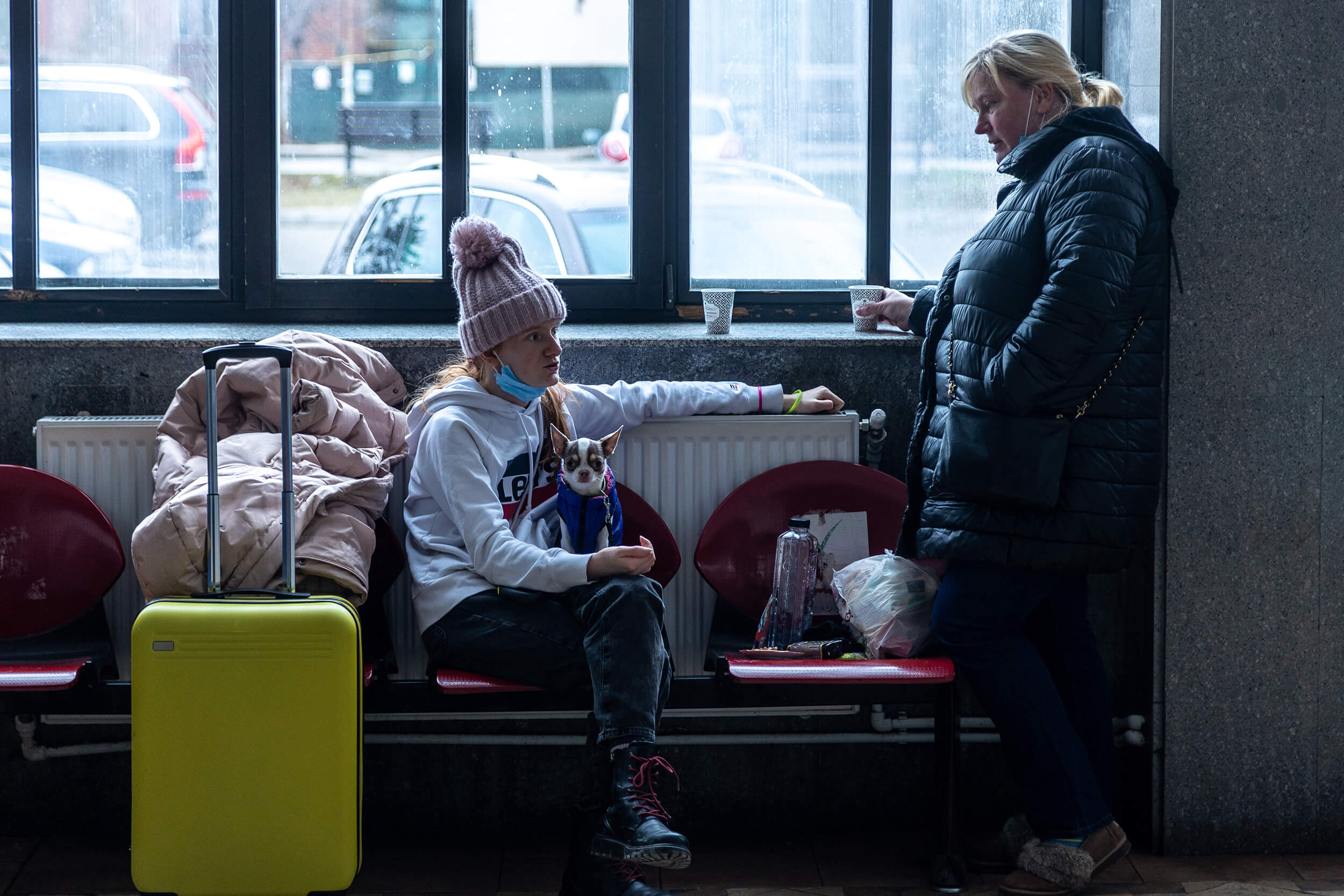 At the Suceava train station in Suceava, Romania, a transportation hub only 26 miles away from the border, a Ukrainian woman holds her dog while waiting to catch a train to Bucharest.