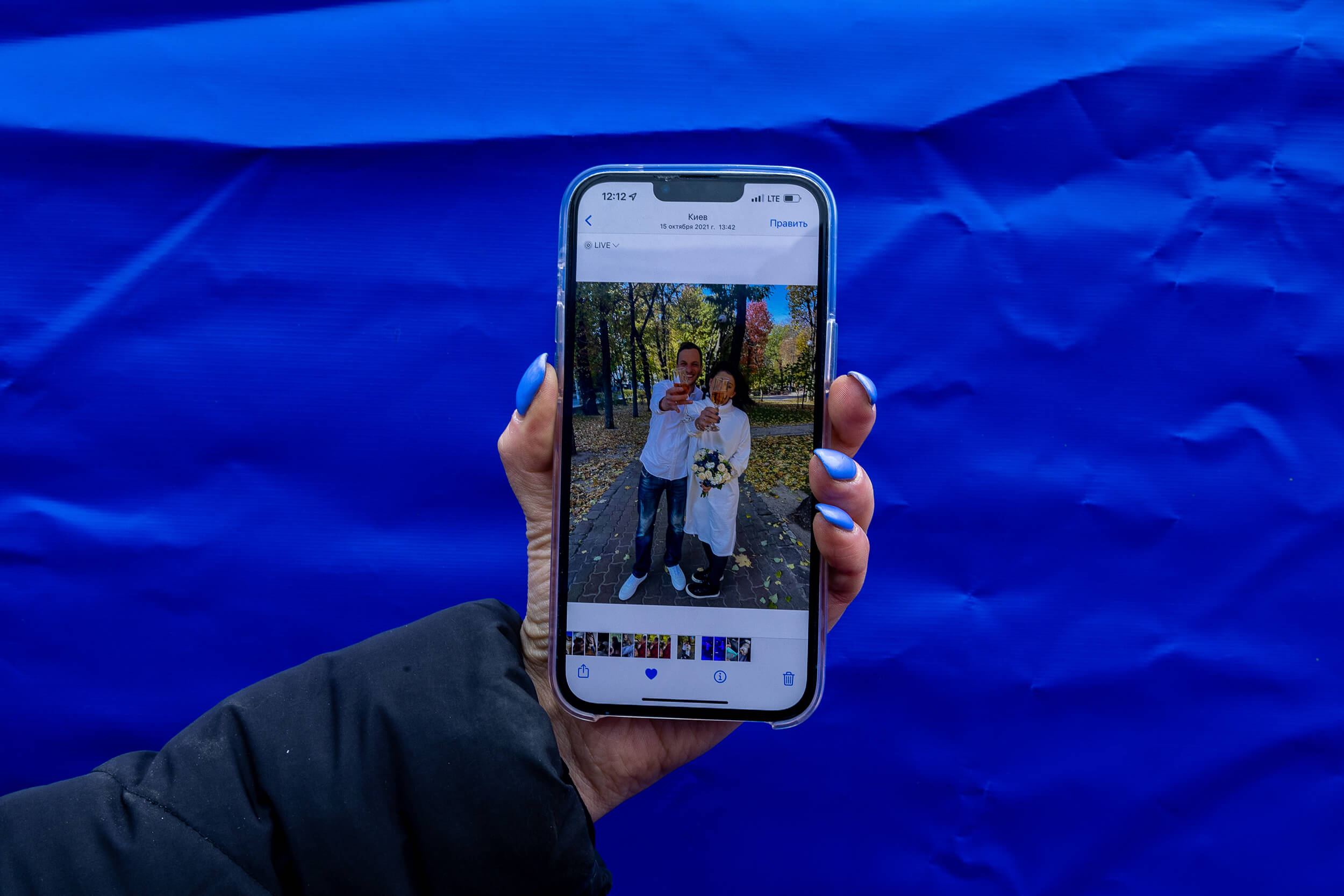 Upon her arrival at the Siret border crossing after escaping shelling in Kiev, 32-year-old Alona shows a photo of her wedding, celebrated last October, on her mobile phone. Her husband, Nikita, has remained in Kiev.