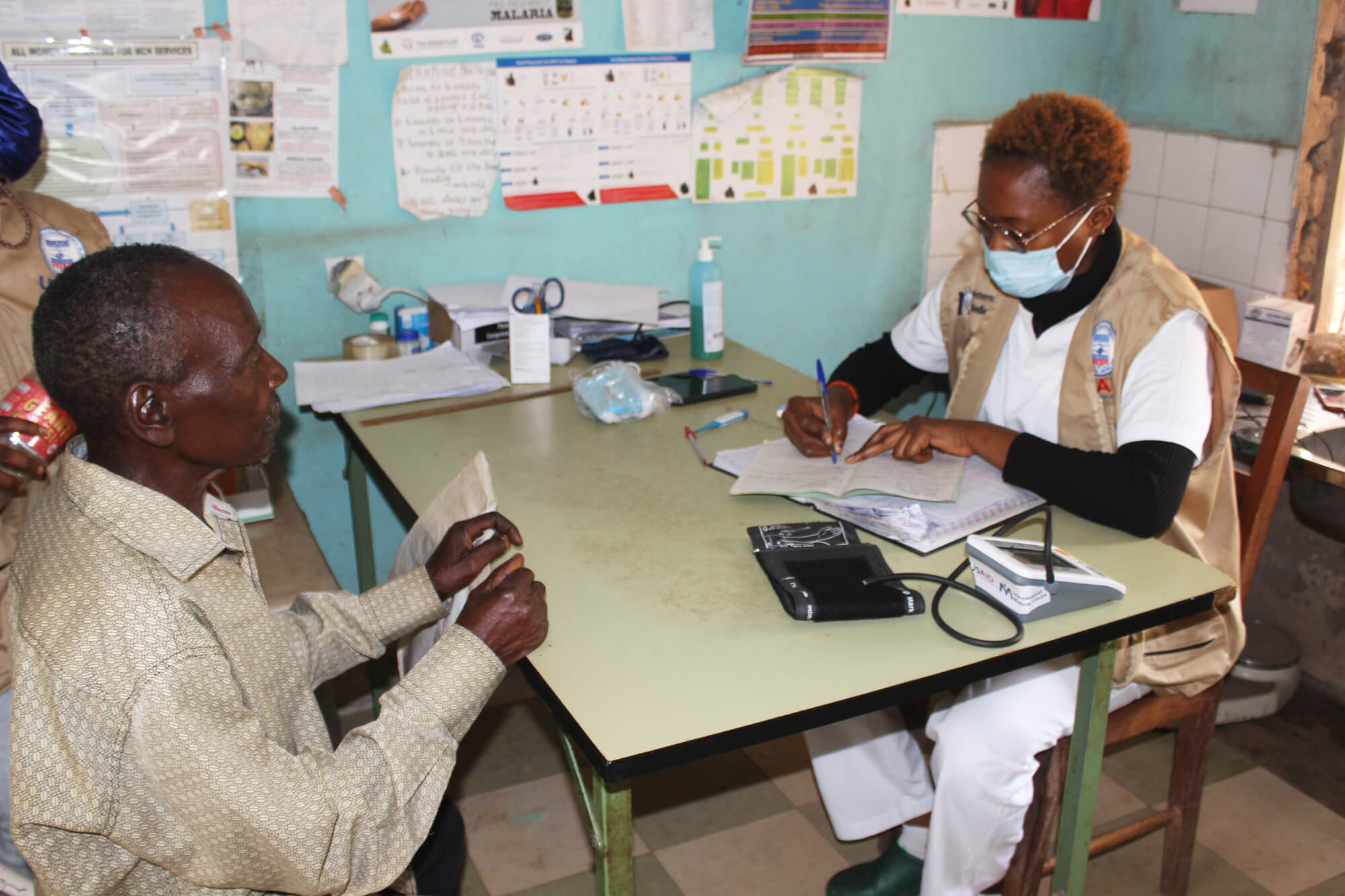 Judit Manyong, a nurse in Konda Integrated Health Center in northwest Cameroon, screens a patient prior to surgery. Konda IHC is an MoH health facility we support in the northwest region, which has been affected by crisis since 2016.