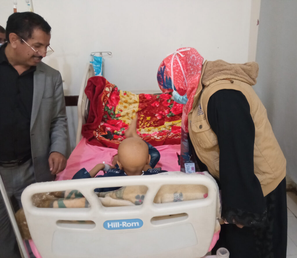 Our Health Program manager Nebras Khaled and the cancer center’s manager visit with a pediatric cancer patient at the NOC in early May.