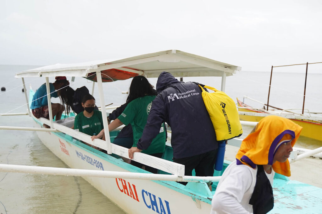Staff members load the boat at Halian Island to return to Siargao Island.