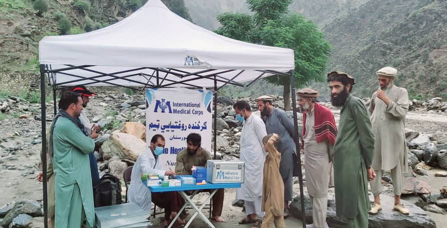 A mobile team provides primary healthcare services after a flash flood in Kamdish, Nuristan.