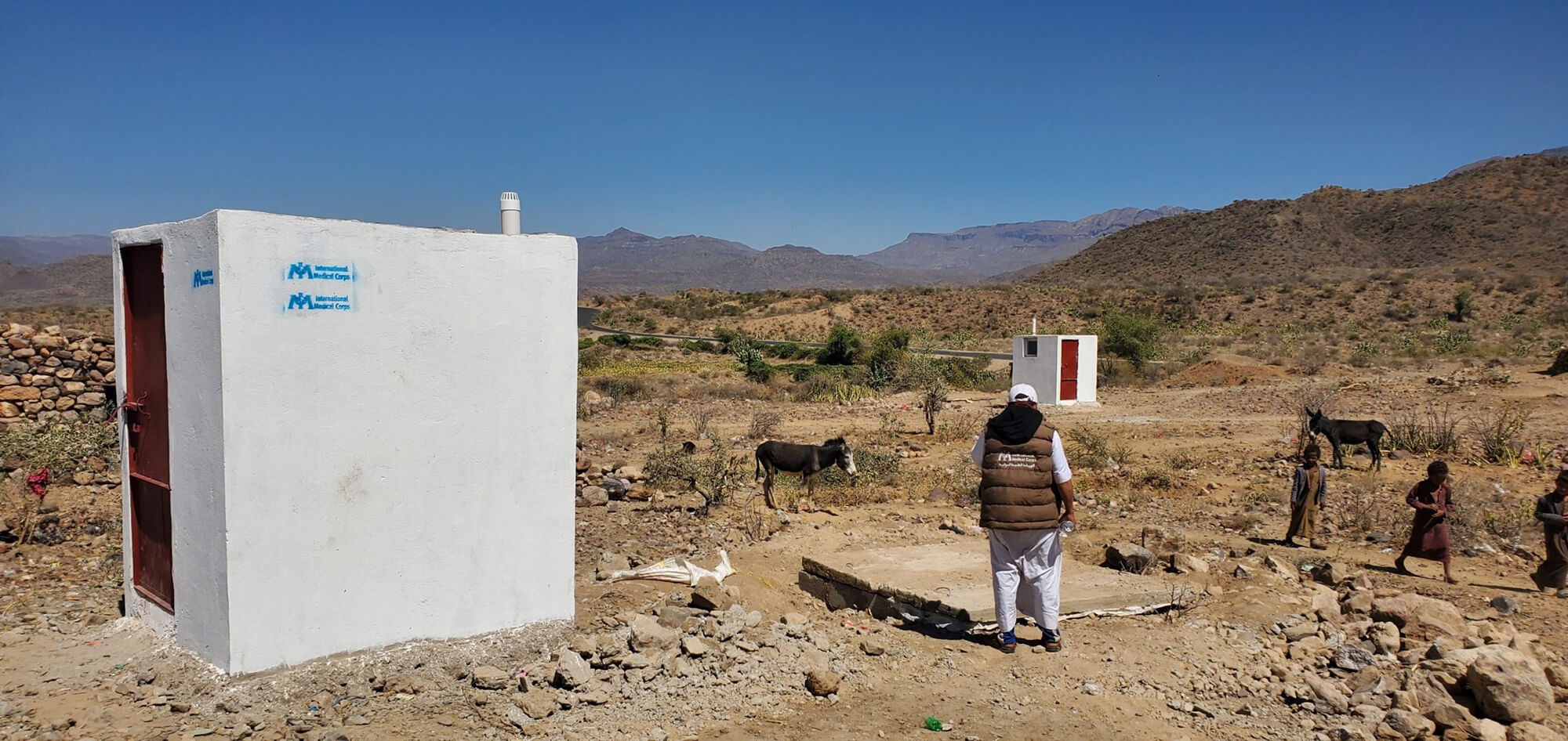 Amer Mohammed, Senior WASH Engineer, surveys the latrine project at Al-Barza IDP camp in Yemen.