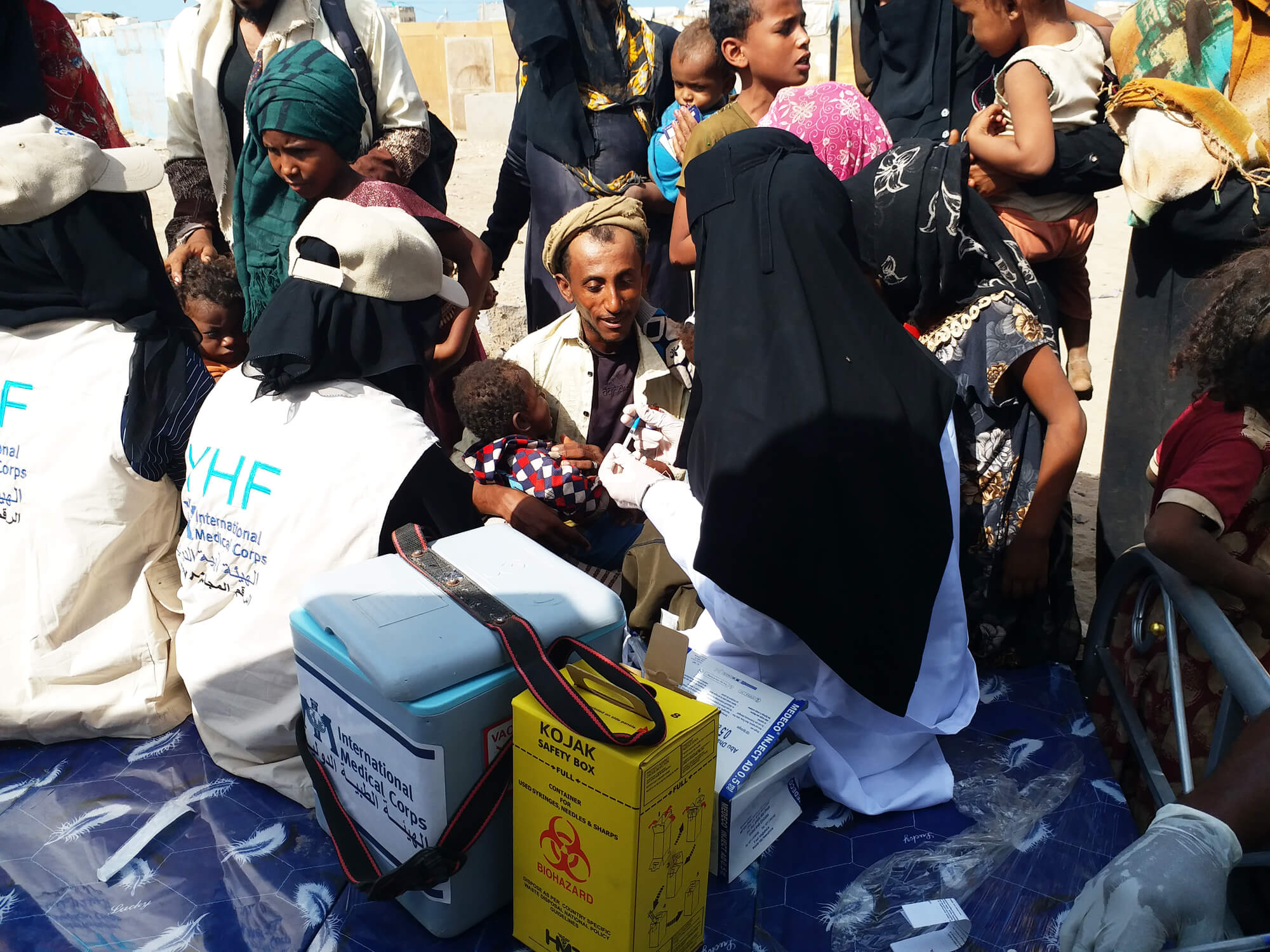 An International Medical Corps mobile medical team provides vaccinations against measles to residents of the Shathiley displacement camp, in the Al Mukha district of Taizz governorate in southwestern Yemen. The families were forced to flee fighting in their home areas elsewhere in the region. We recruit and train residents of these communities as health volunteers who explain to their neighbours the benefits of good public health, including the importance of immunisation.