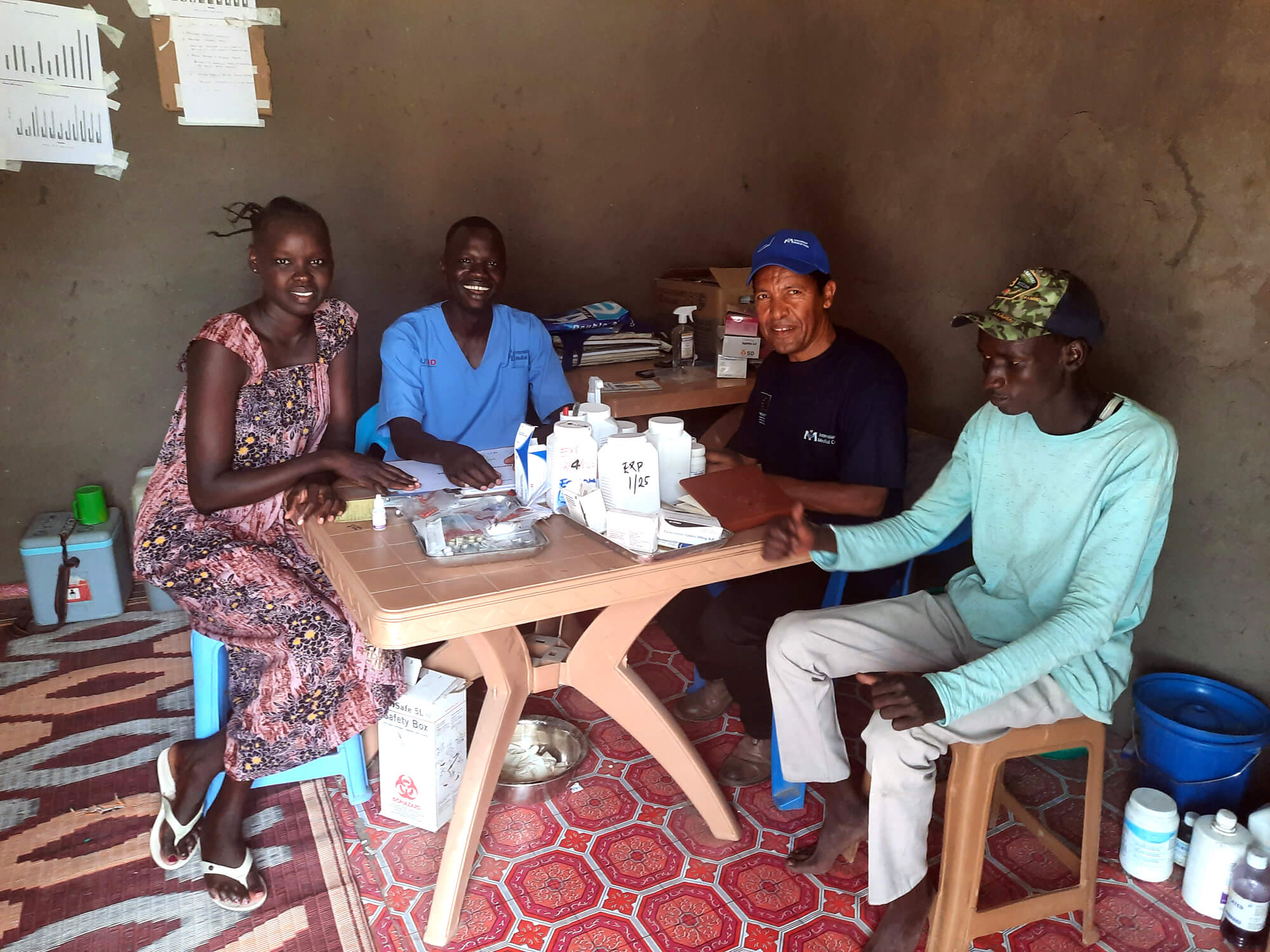 Hailu Bekele (second from right) meets with midwives at an International Medical Corps-supported health facility to review registration books, identify gaps and discuss areas of improvement.