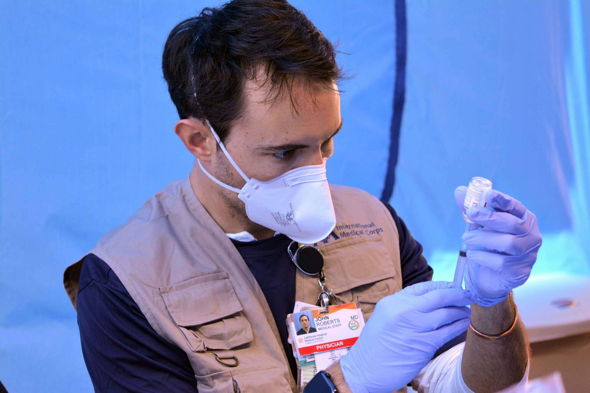 Dr. John Roberts prepares a COVID-19 vaccine dose at Kedren Community Health Centre in South Los Angeles.