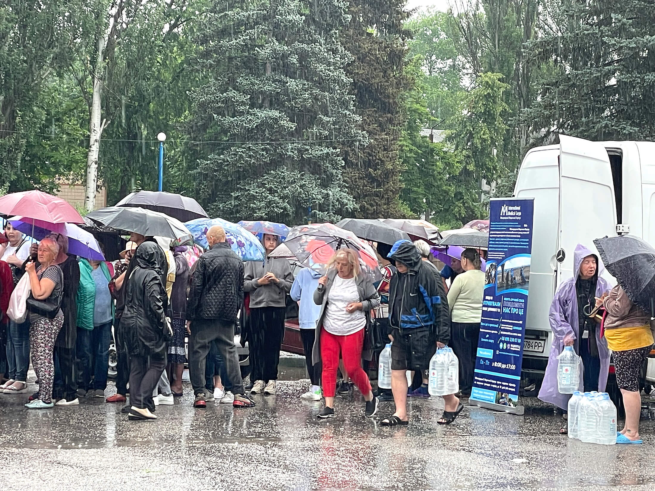 Despite a series of intense rainstorms following the breach of the dam, International Medical Corps teams continued working to provide clean water to community residents.