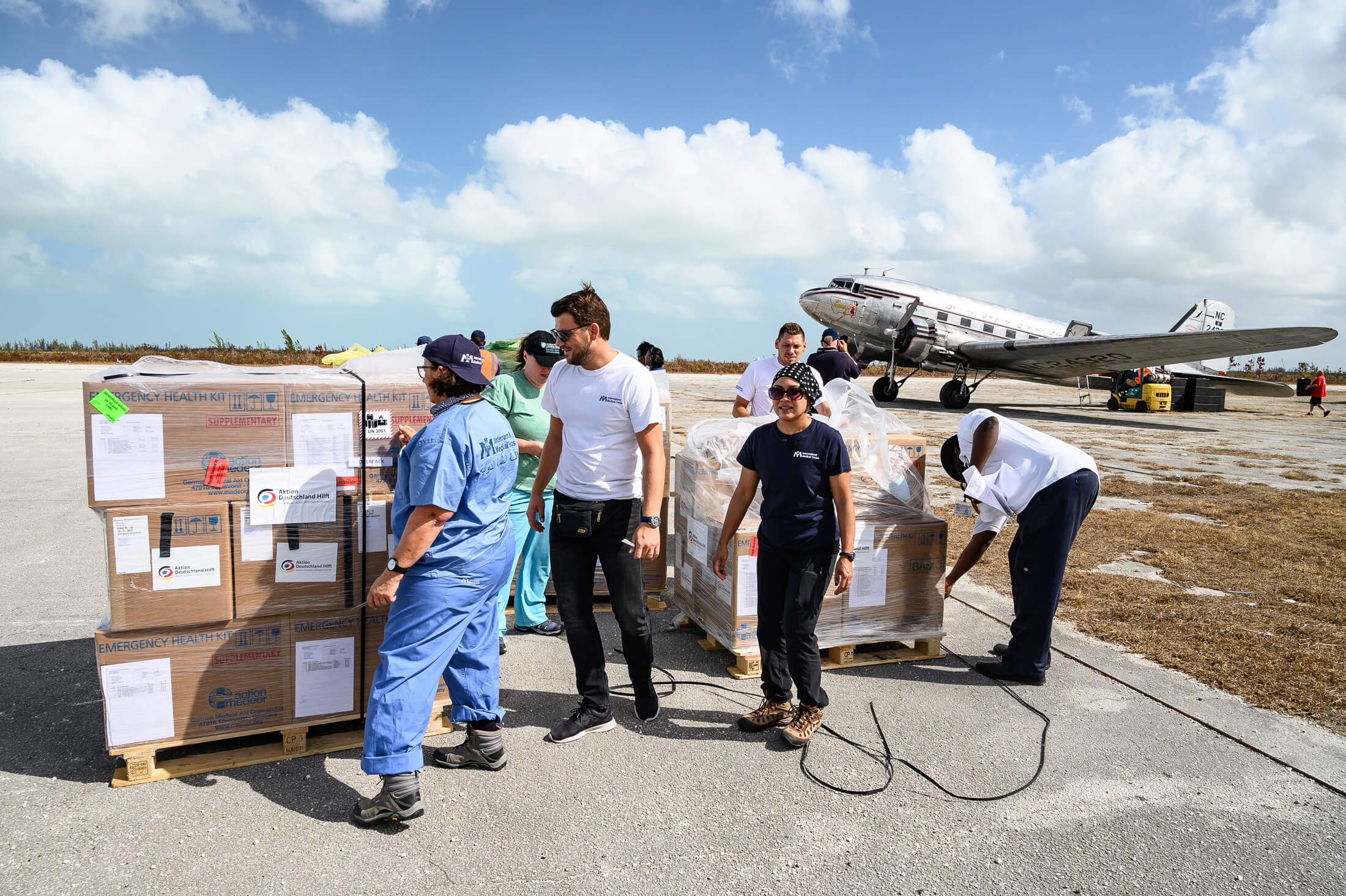 International Medical Corps Emergency Response Team members unload a shipment of emergency supplies in Freeport, the Bahamas, in the wake of 2019’s Hurricane Dorian. The shipments contained essential medicines, consumables and other equipment necessary to serve hurricane-stricken communities.