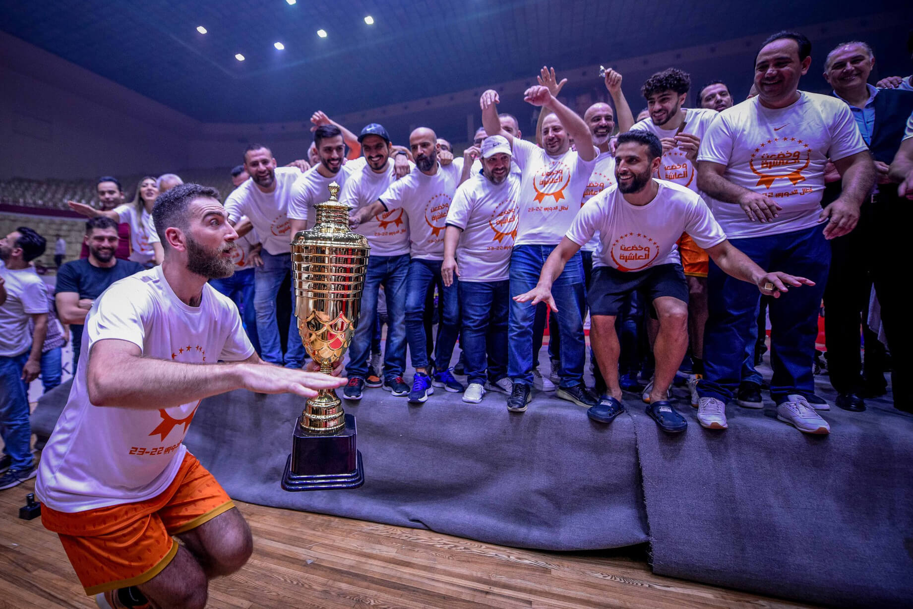 Sharif holds the championship trophy in celebration.