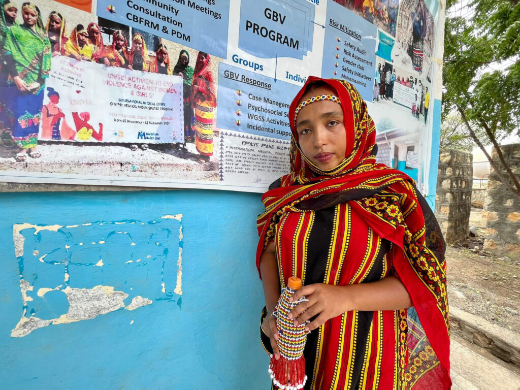 International Medical Corps Assistant GBV Response Officer Sofia Seid stands in front of the WGSS in Chifra.