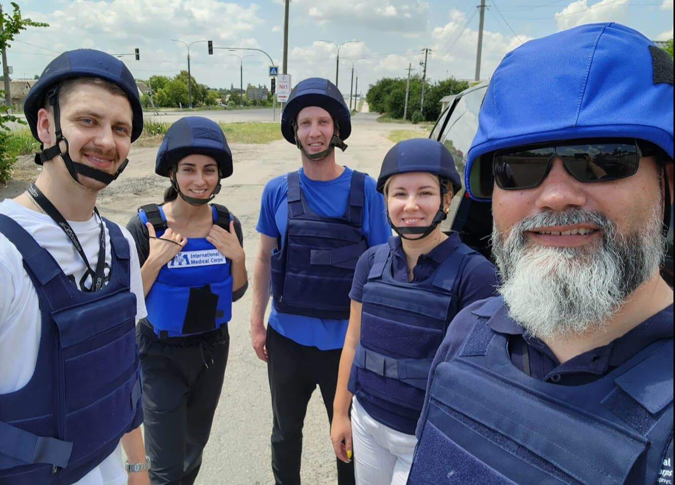 Global Security Advisor Jose Hernandez (right) prepares to deliver dignity and hygiene kits with drivers and members of our gender-based violence team in the northeast part of Kherson oblast in June 2023. The area had been experiencing artillery fire and shelling.