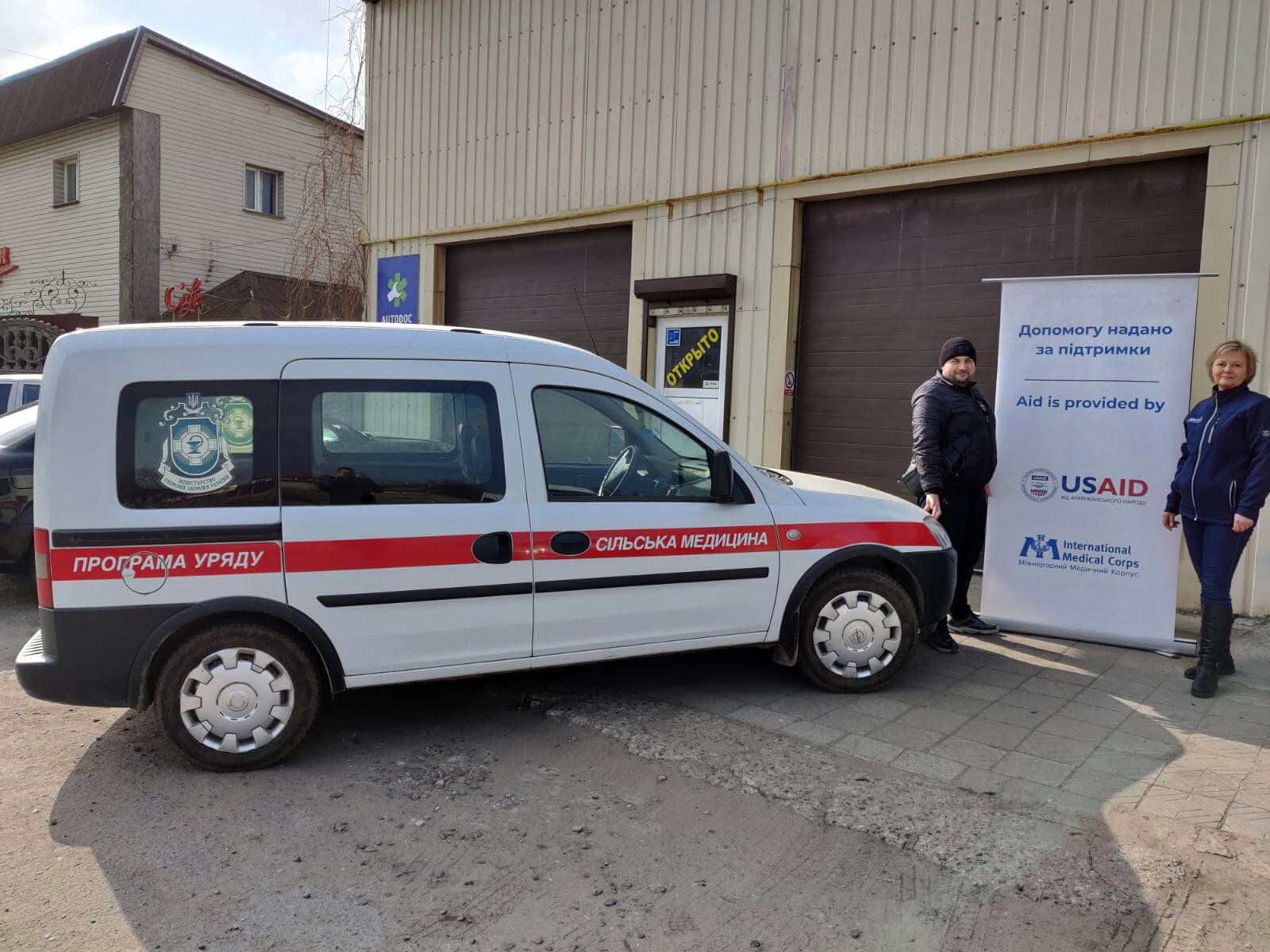 International Medical Corps staff stand next to one of the repaired ambulances from the Mykolaiv Regional Center for Medical Aid and Disaster Medicine.