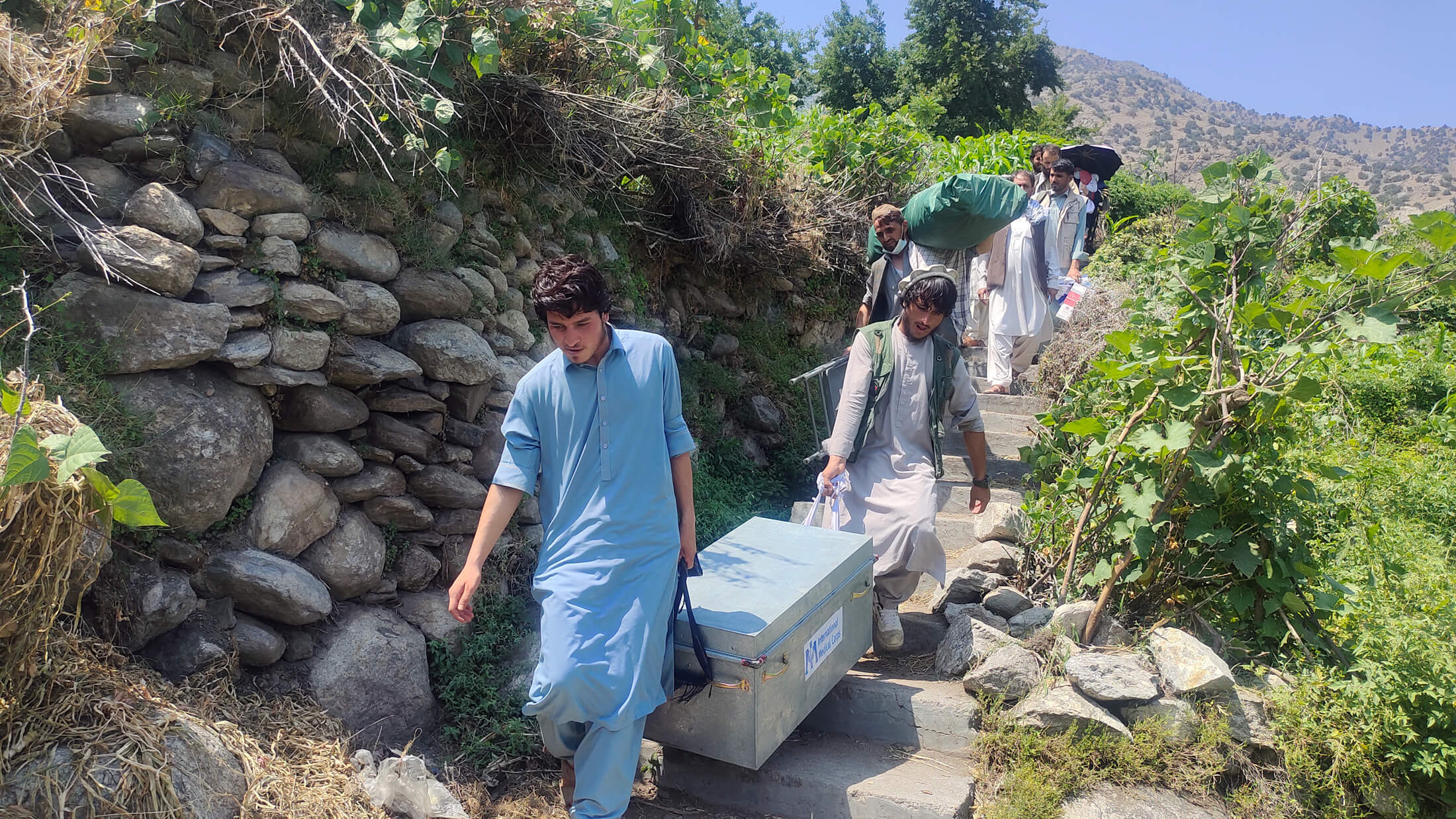 International Medical Corps team members carry essential medicines and even school supplies as they travel across rocky mountain ranges to the remote village of Ziarat in eastern Afghanistan.