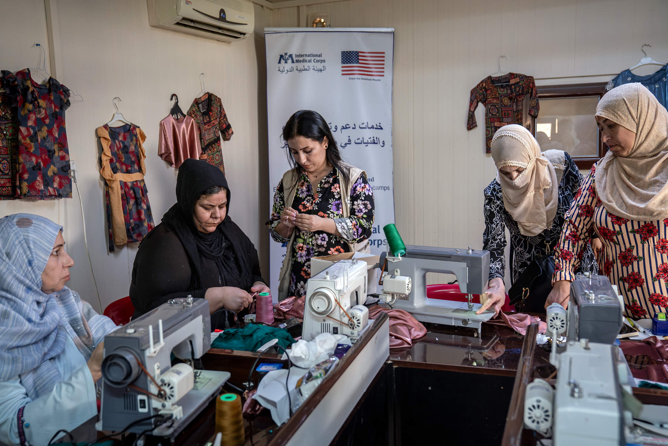 Suaad (left) and other women who live in Domiz 1 camp participate in tailoring training run by International Medical Corps women’s and girls’ safe space facilitator Lava Ibrahim (center).