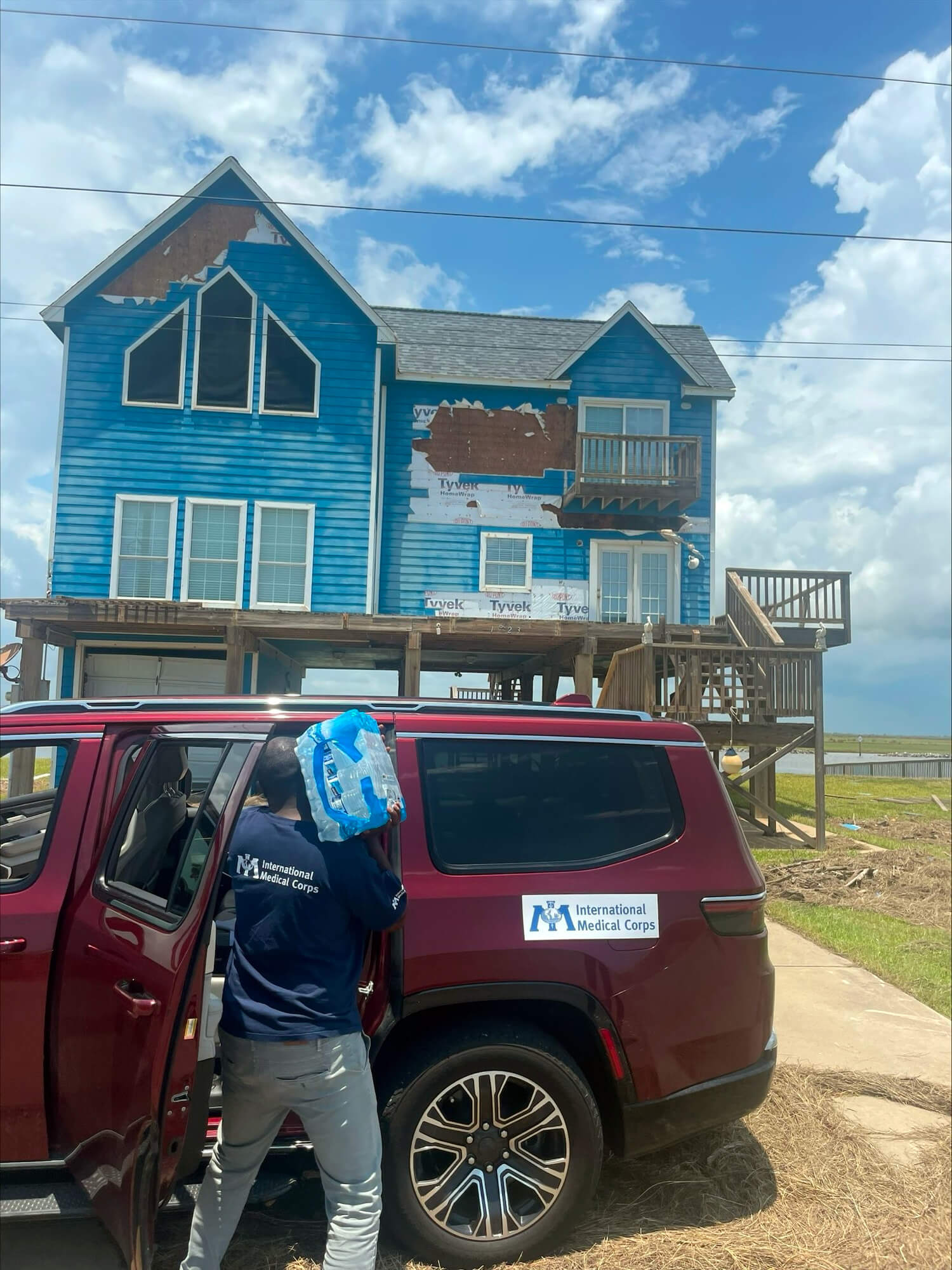 International Medical Corps staff delivers water in the aftermath of Hurricane Beryl.