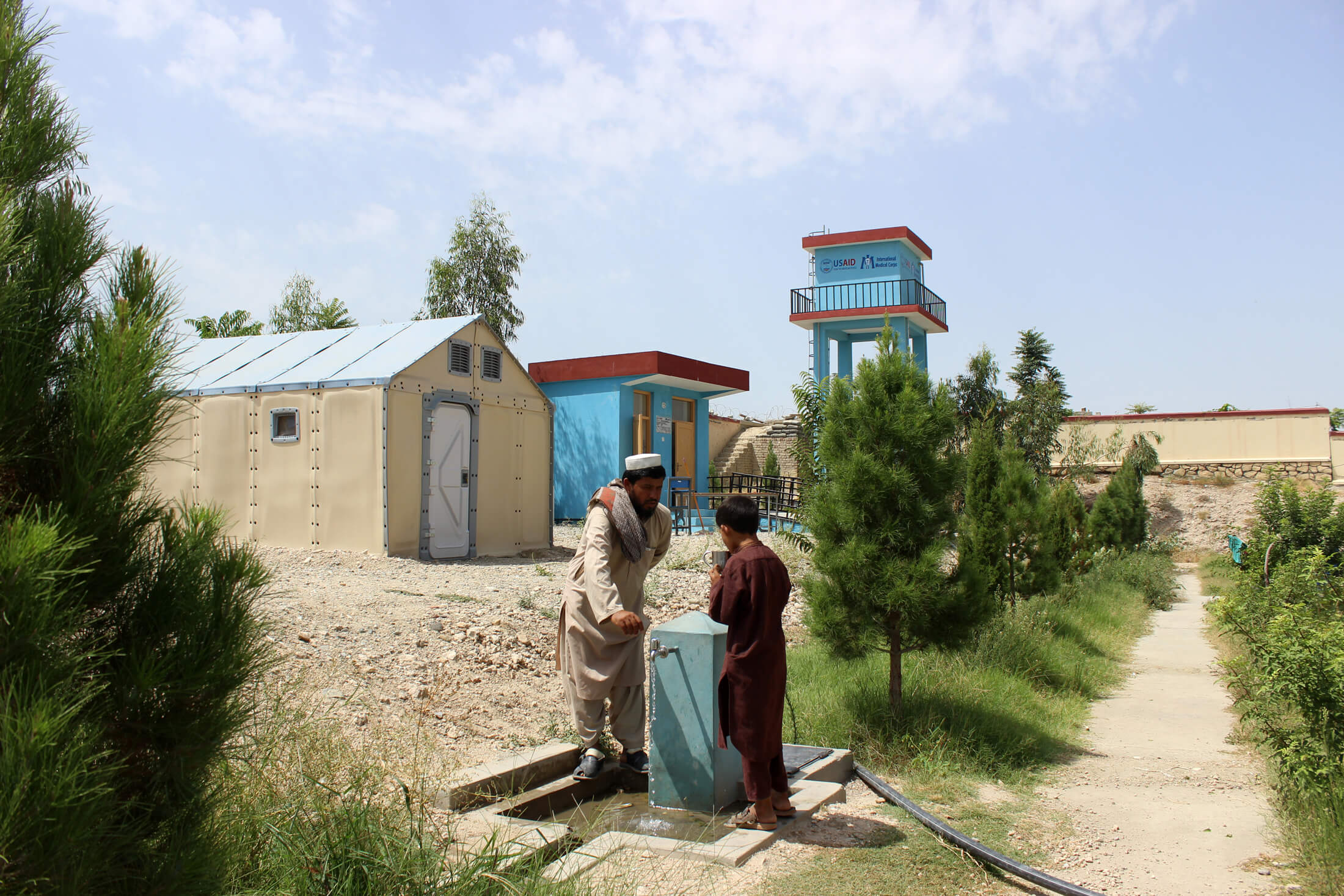 Villagers drink clean, safe water from the new water supply system installed by International Medical Corps at the Pewa Health Facility in Afghanistan.