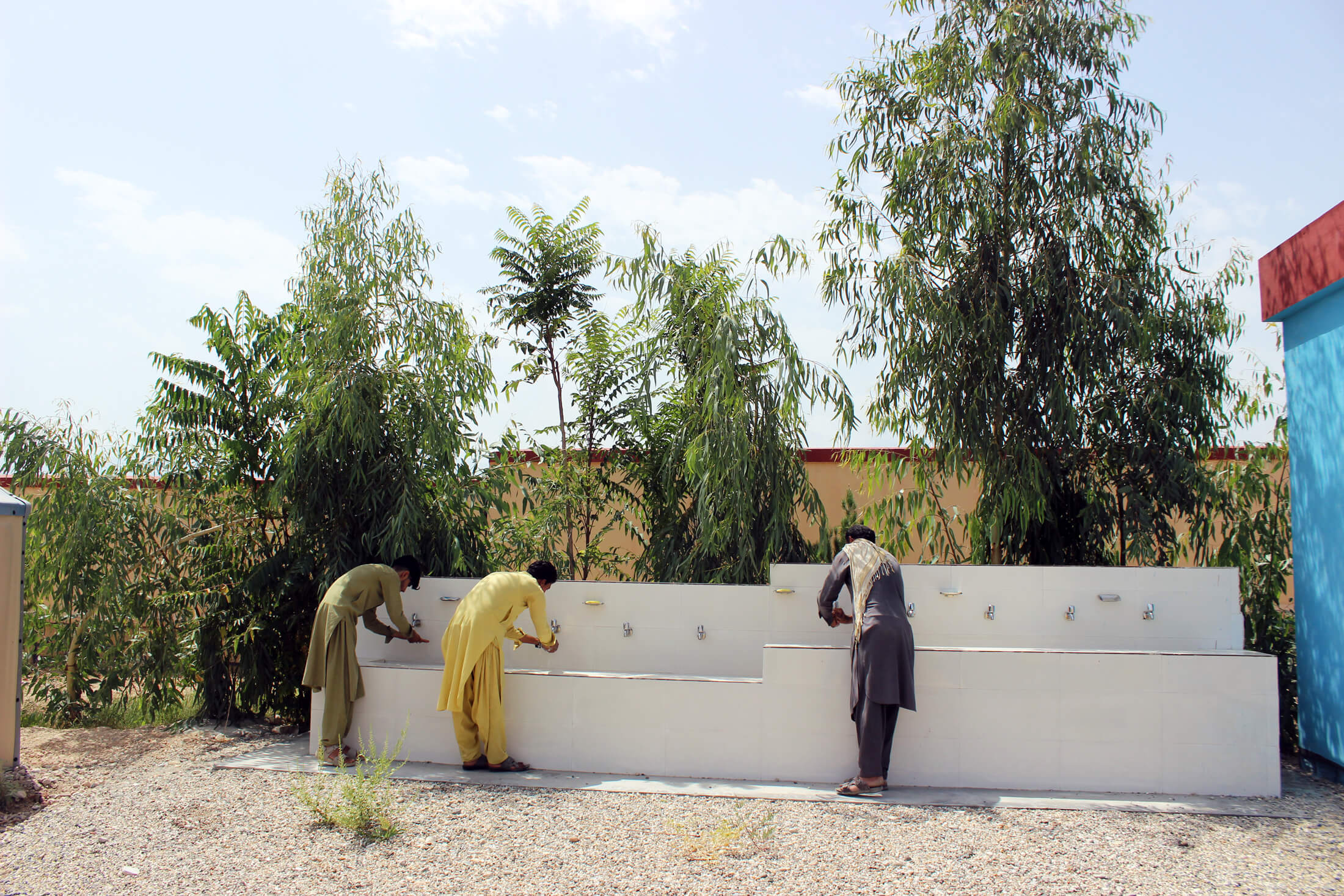 Villagers wash their hands at handwashing stations installed by International Medical Corps at the Pewa Health Facility in Afghanistan.