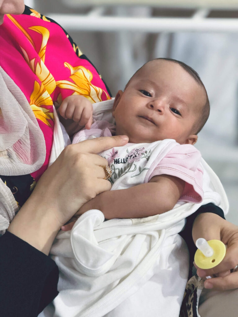 After struggling to become pregnant for more than eight years, Ala’a finally holds one of her babies in her arms.