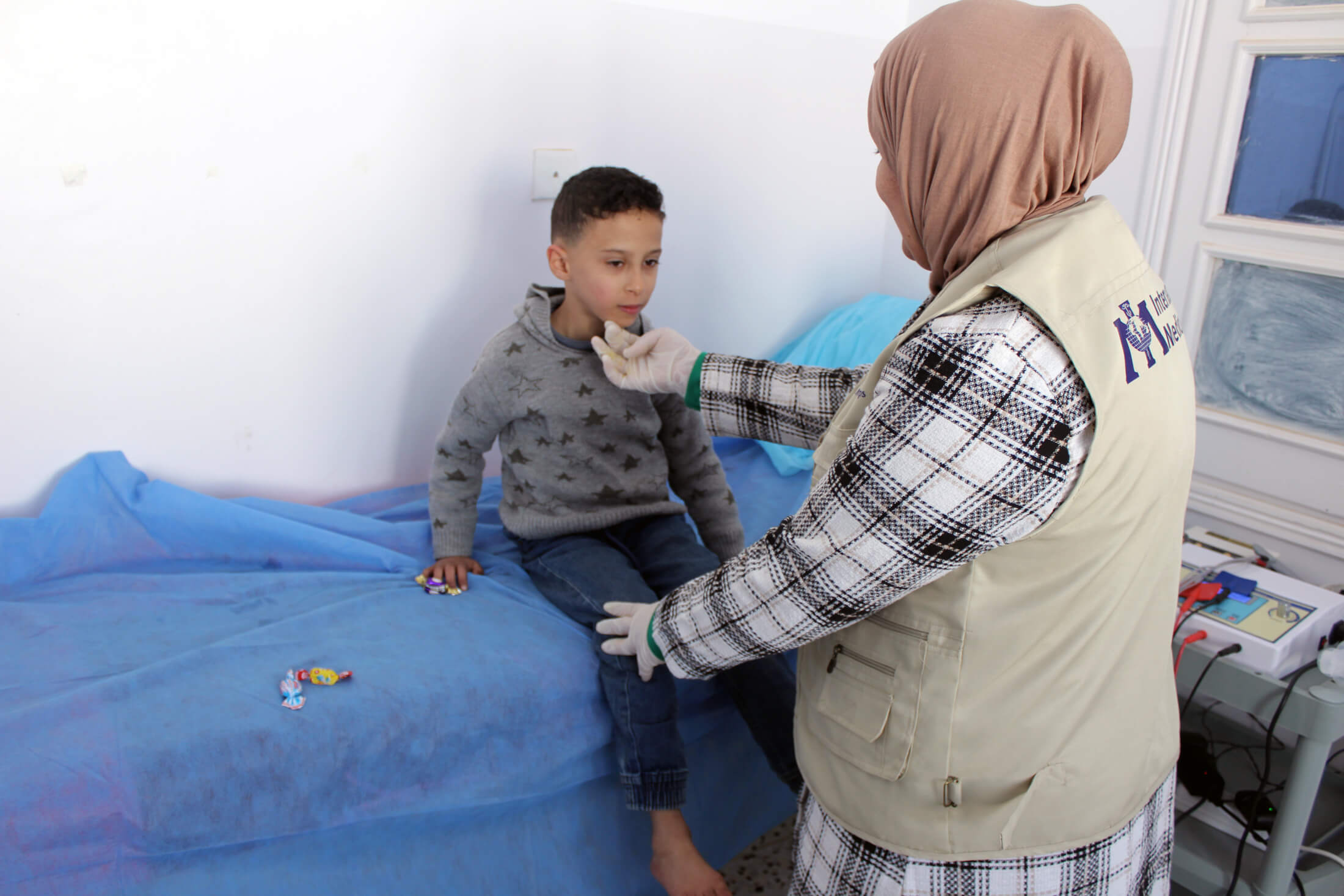 Dr. Mira meets with Muhammad during a physiotherapy session.