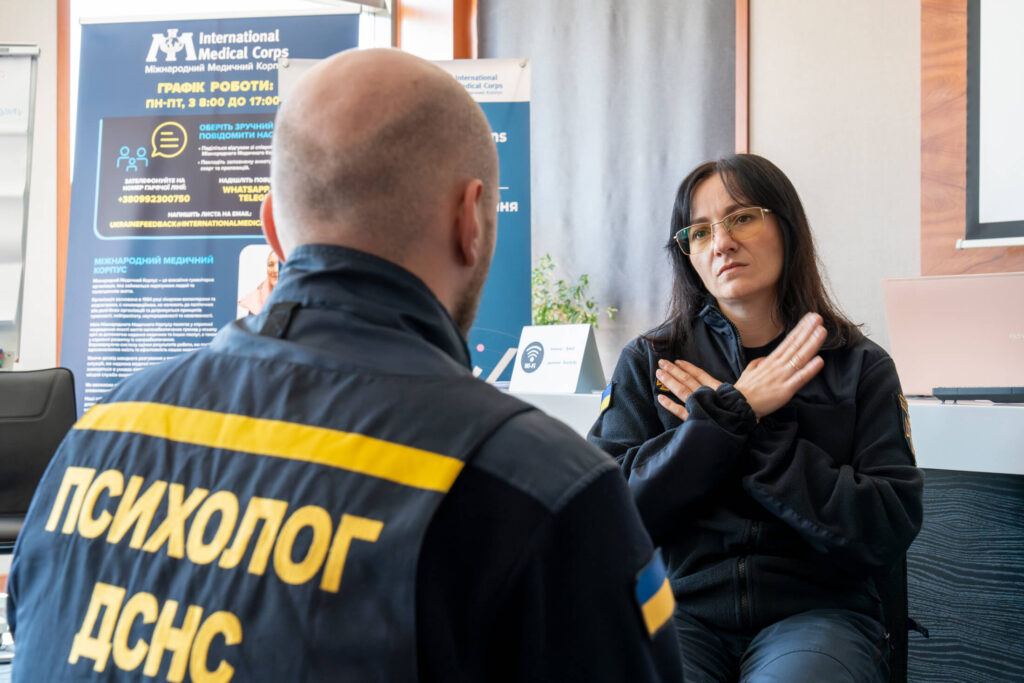 An instructor teaches a relaxation technique during an mhGAP training session in Kyiv in May. Participants included psychologists from Ukraine’s State Emergency Services.