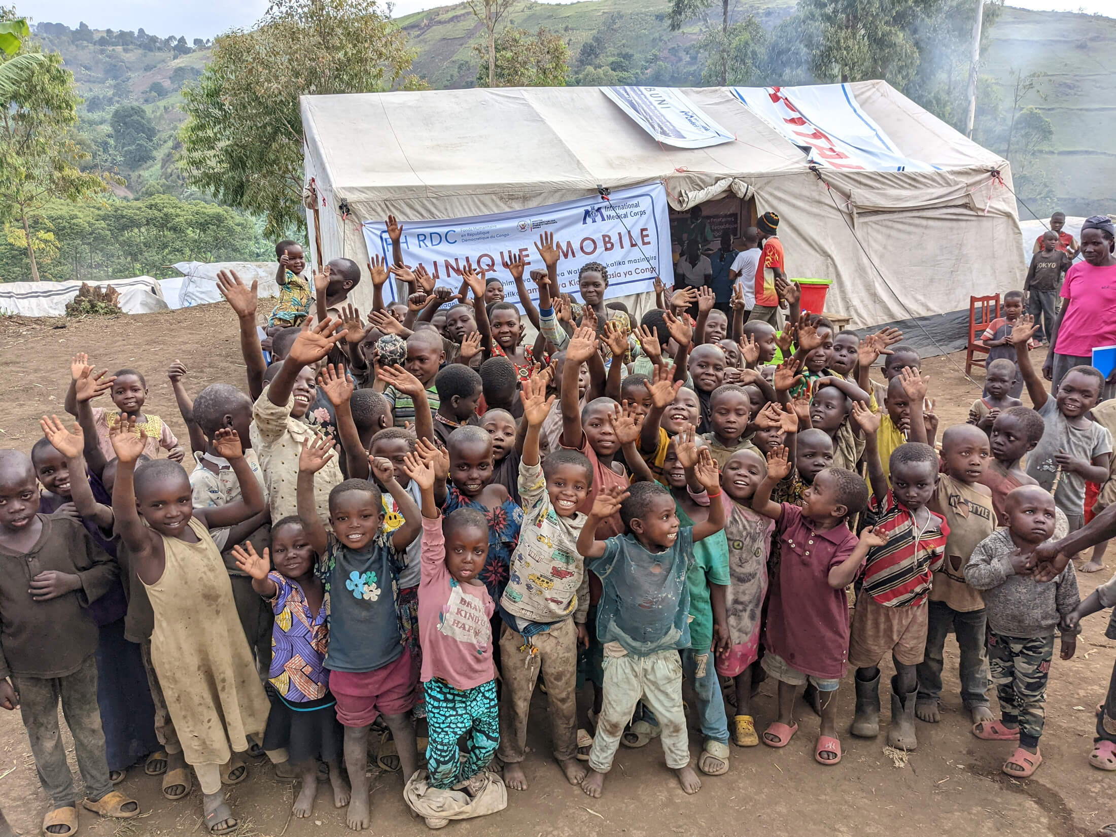 Children smile after receiving healthcare services at our mobile clinic.