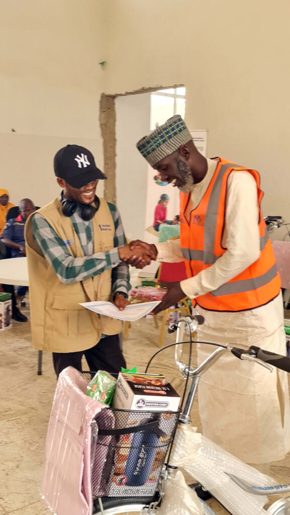 Moses congratulates a CHW on graduating from a nutrition training programme.