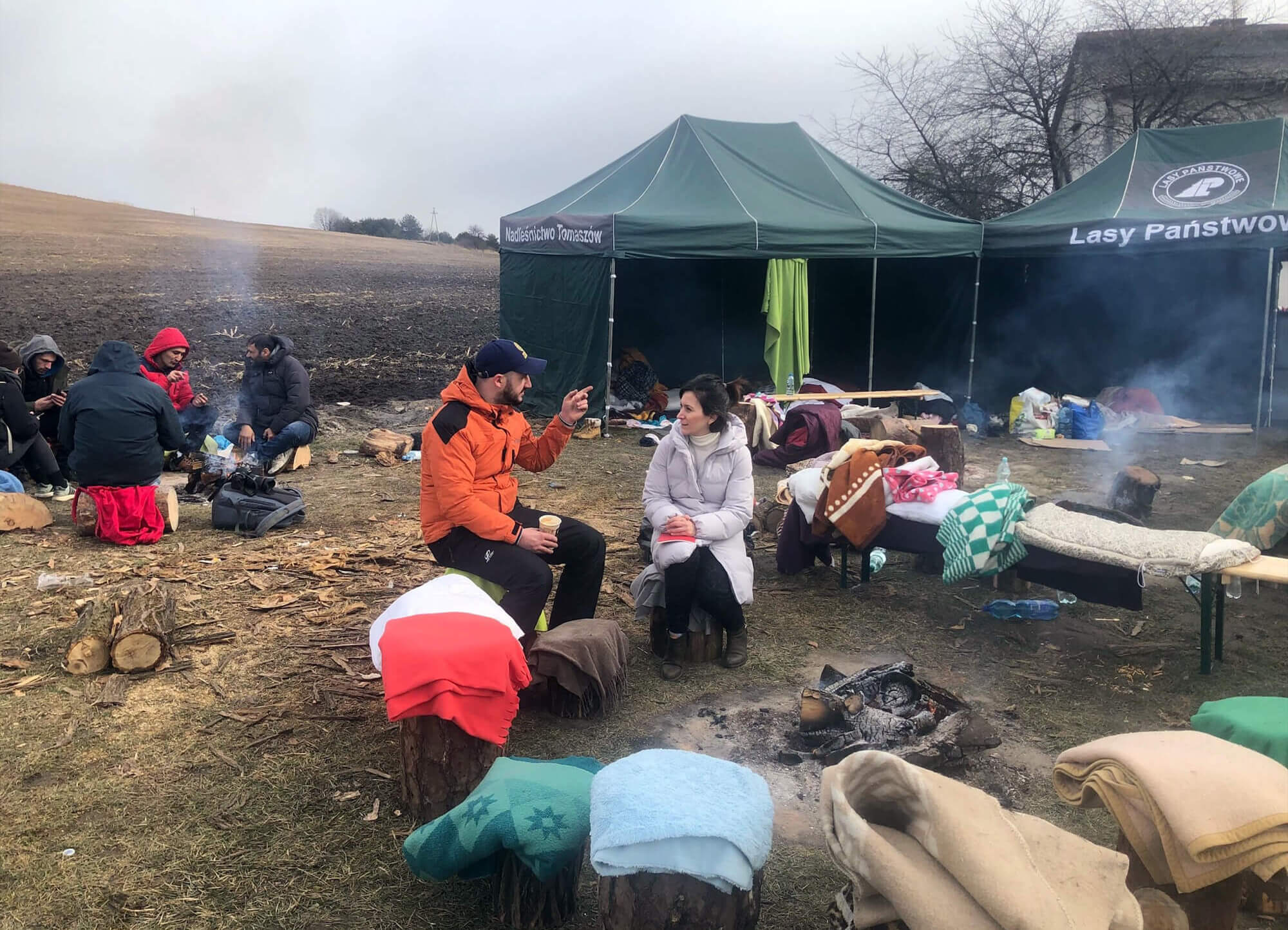 On the Polish side of the border, International Medical Corps Poland Country Director Simge Memisoglu speaks to a Ukrainian man who is waiting for his family to cross into Poland.