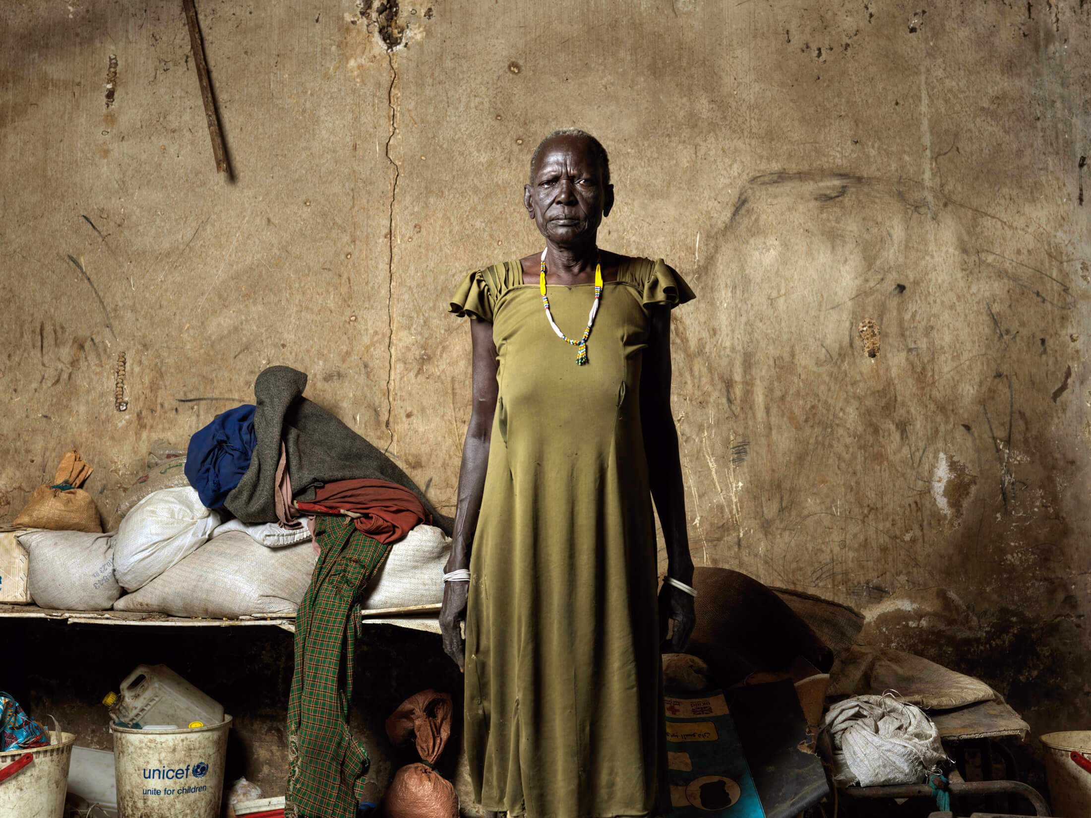 Nyanthon Monybul stands in the abandoned school where she now lives after flooding destroyed her home.