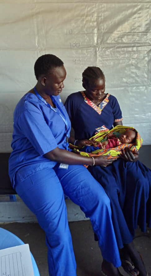 Midwife Sarah Anai Atong shares a moment with the baby’s mother, Nyawech Chamjok Lahm.