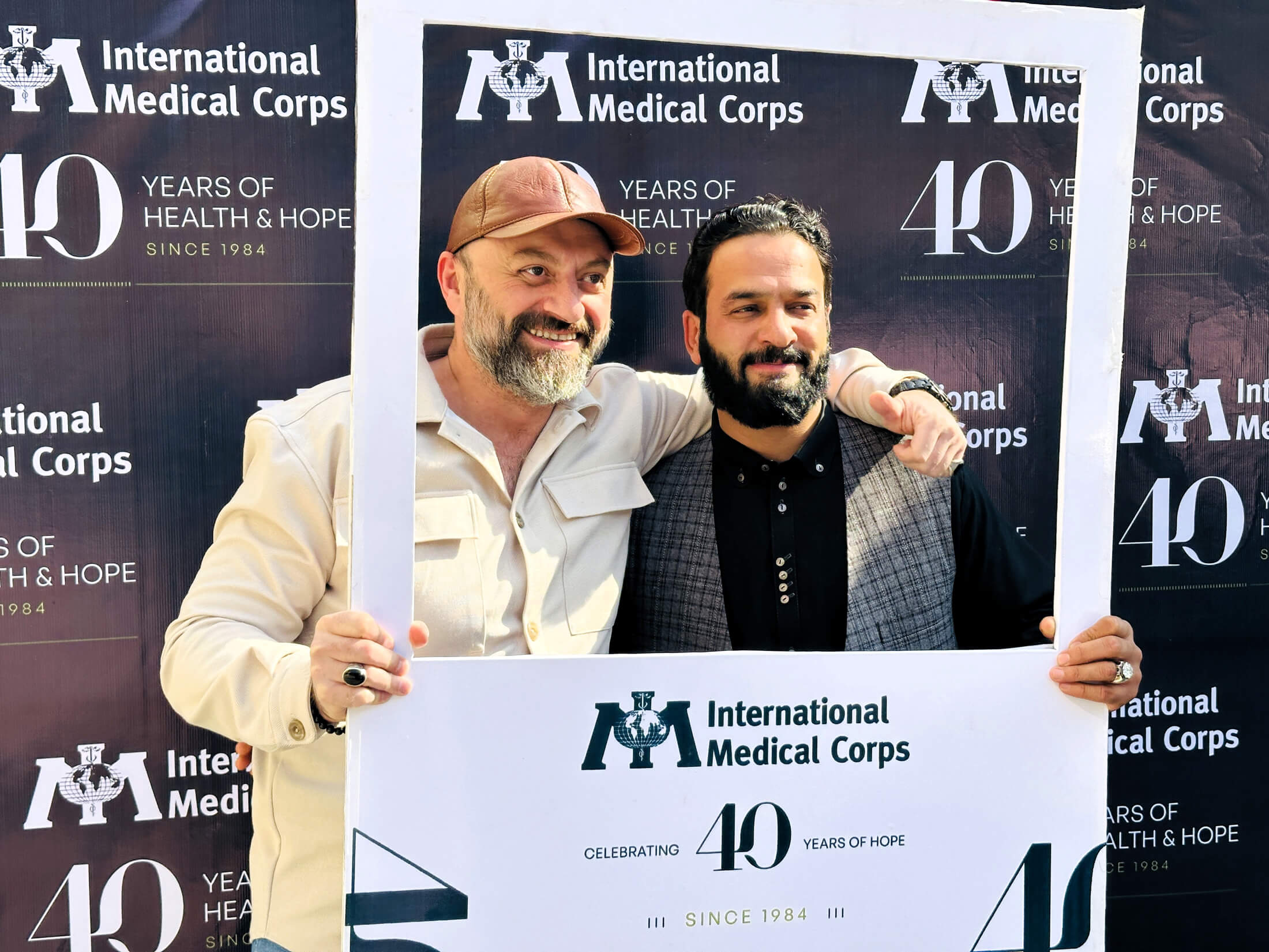 Dr. Vial Alraas, MHPSS Coordinator (left), and Sayed Mohammad Edrees, Security Manager (right), at the 40th anniversary event in Kabul.