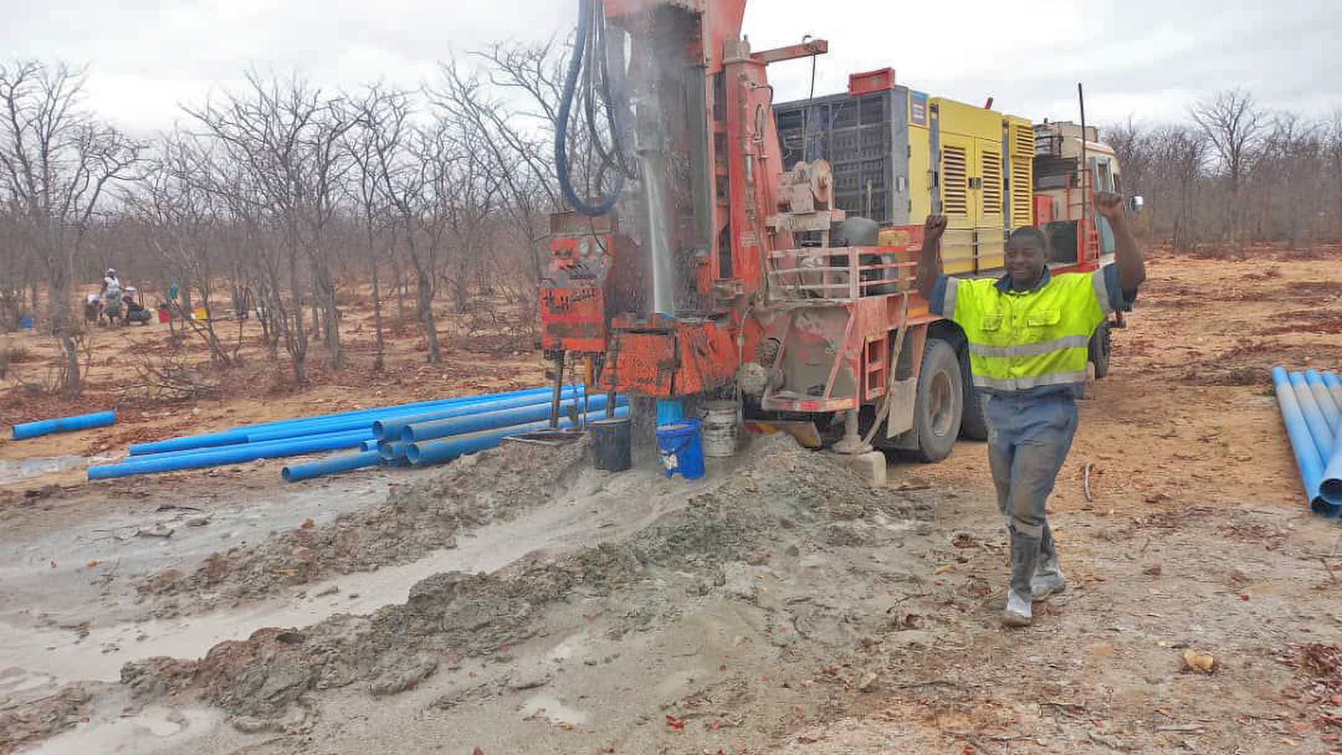 A drill operator celebrates the successful establishment of a new waterpoint.